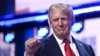 US former President and 2024 Republican presidential candidate Donald Trump holds up a fist onstage during the last day of the 2024 Republican National Convention at the Fiserv Forum in Milwaukee, Wisconsin, on July 18, 2024.